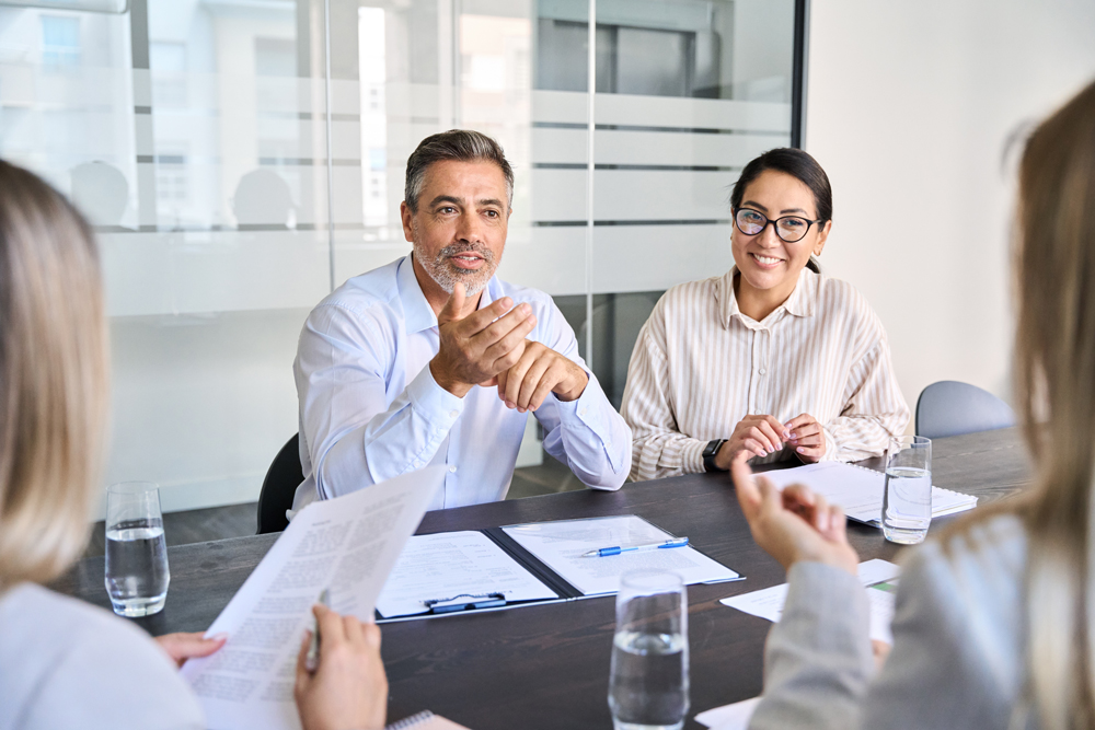 People sitting at a conference table discussing business