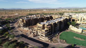 An aerial view of a large set of buildings, Sagewood, with a green space to the right-hand side.