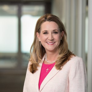 A headshot of a woman, Monica Friedman, smiling at the camera.