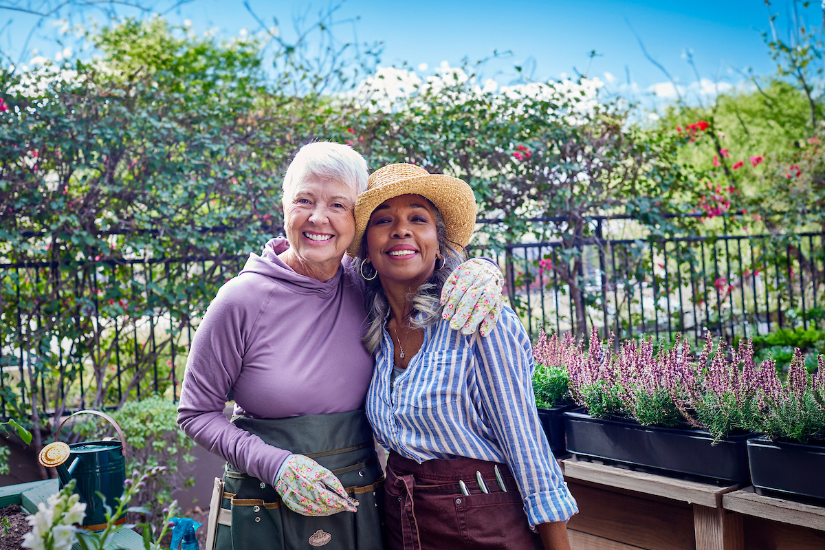 Two women at senior living community in the garden.