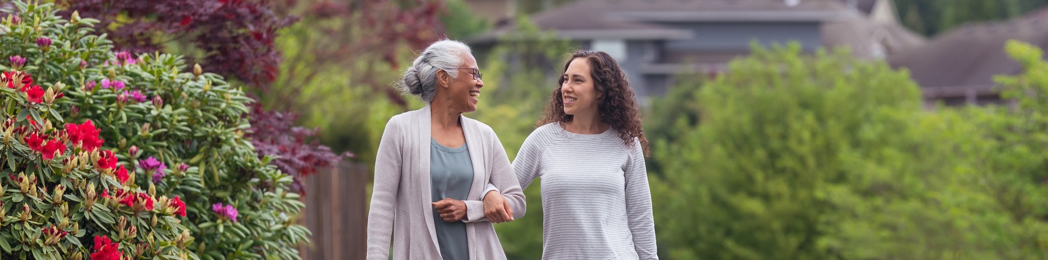 A mother and daughter walking through a garden